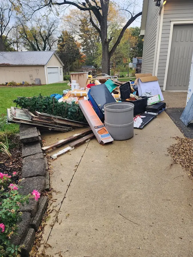 Dumpster being loaded with debris for 3 Yard Dumpster Rental in St. Marys